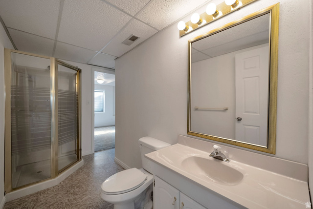 11922 Bluff View Drive Sandy, UT 84092 - Photo 20 of 30 Full bath featuring a drop ceiling, vanity, a stall shower, and light floors