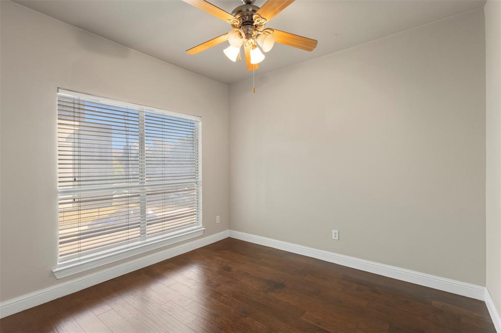 5617 Bryan Parkway, Unit 2 Dallas, TX 75206 - Photo 12 of 33 an empty room with a window and wooden floor