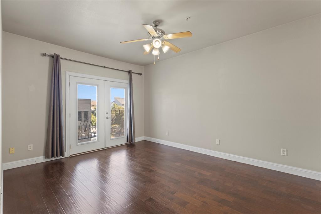 5617 Bryan Parkway, Unit 2 Dallas, TX 75206 - Photo 16 of 33 a view of an empty room with wooden floor and a window