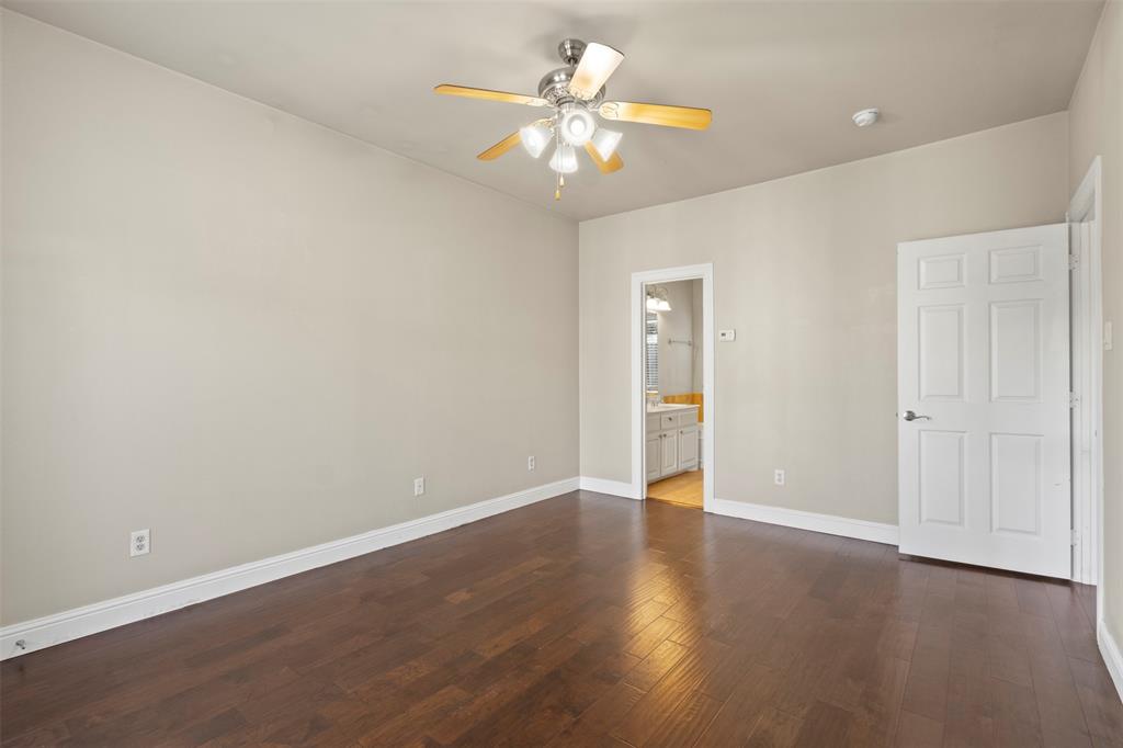 5617 Bryan Parkway, Unit 2 Dallas, TX 75206 - Photo 19 of 33 a view of an empty room with chandelier fan and wooden floor