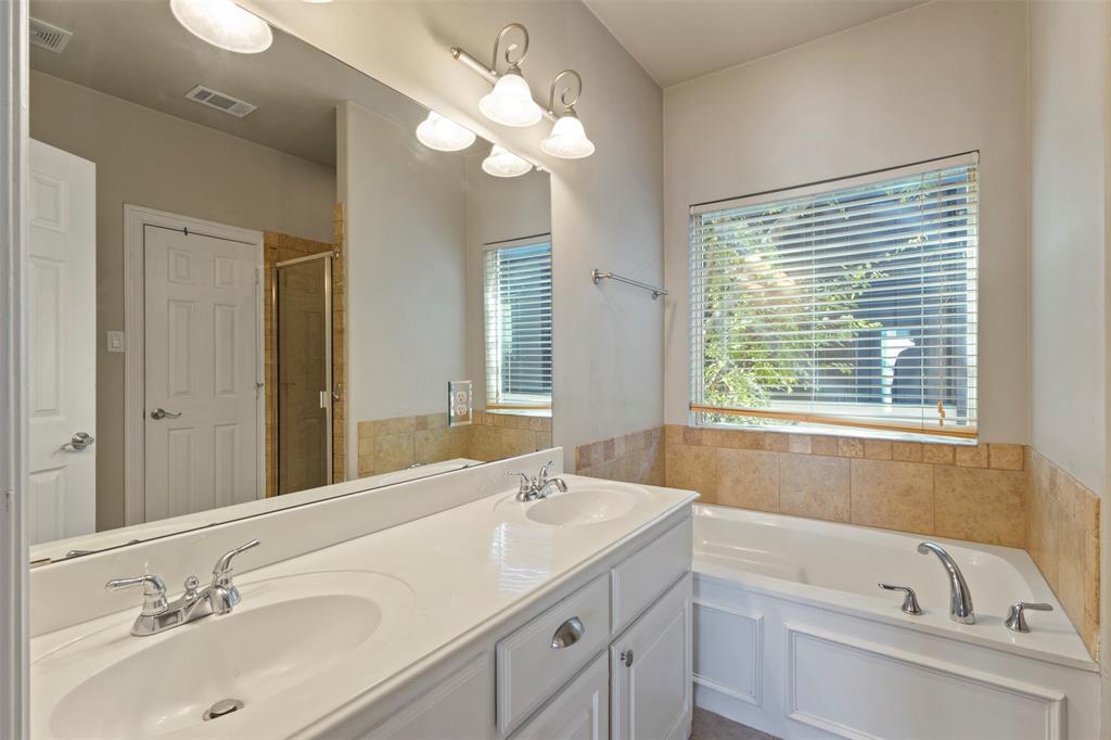 5617 Bryan Parkway, Unit 2 Dallas, TX 75206 - Photo 20 of 33 a bathroom with a tub a sink double vanity granite and a mirror