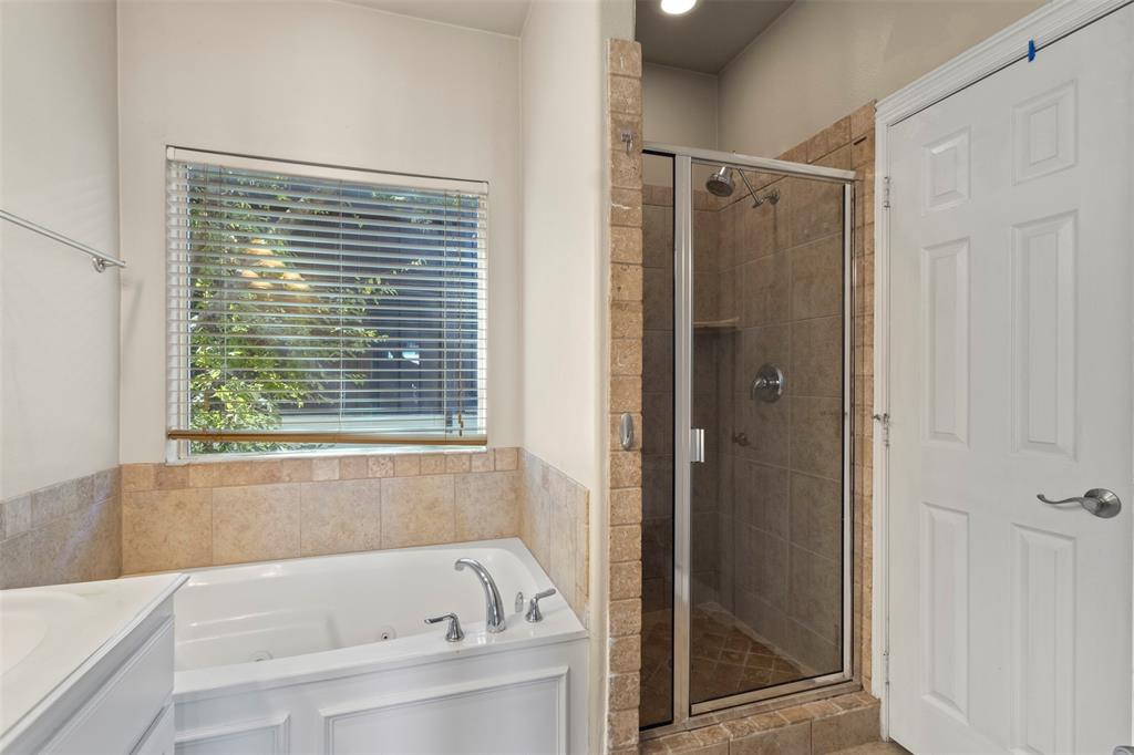 5617 Bryan Parkway, Unit 2 Dallas, TX 75206 - Photo 21 of 33 a bathroom with a bathtub and a shower