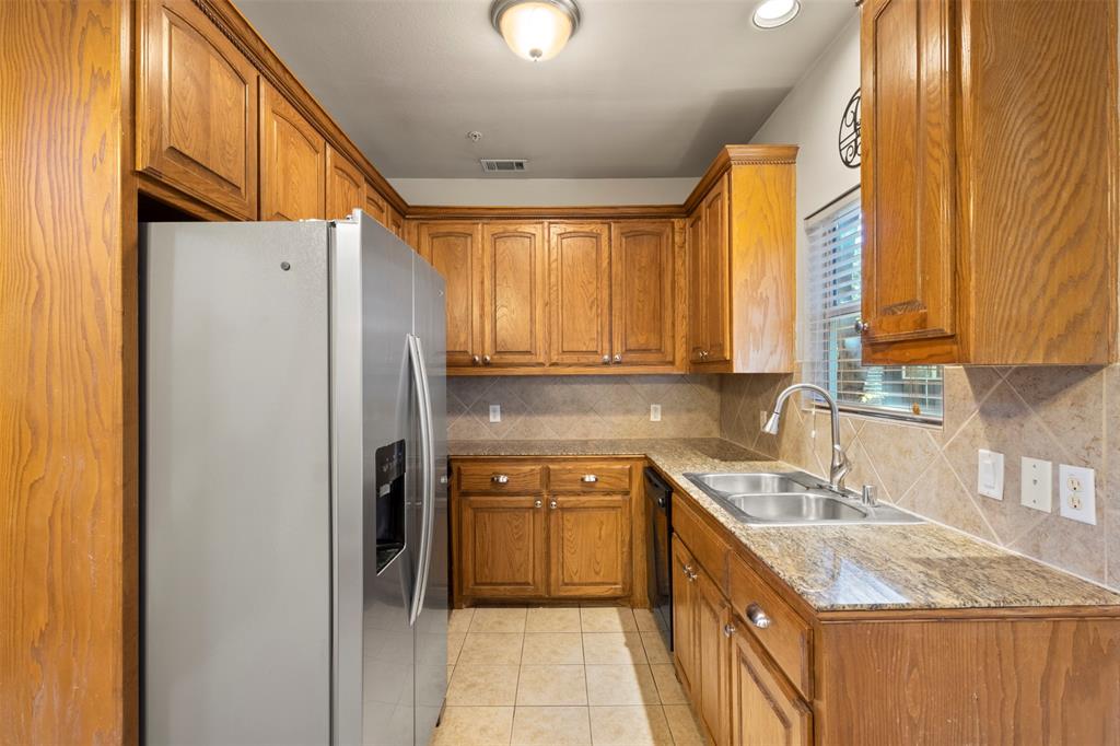 5617 Bryan Parkway, Unit 2 Dallas, TX 75206 - Photo 7 of 33 a kitchen with a sink a refrigerator and cabinets