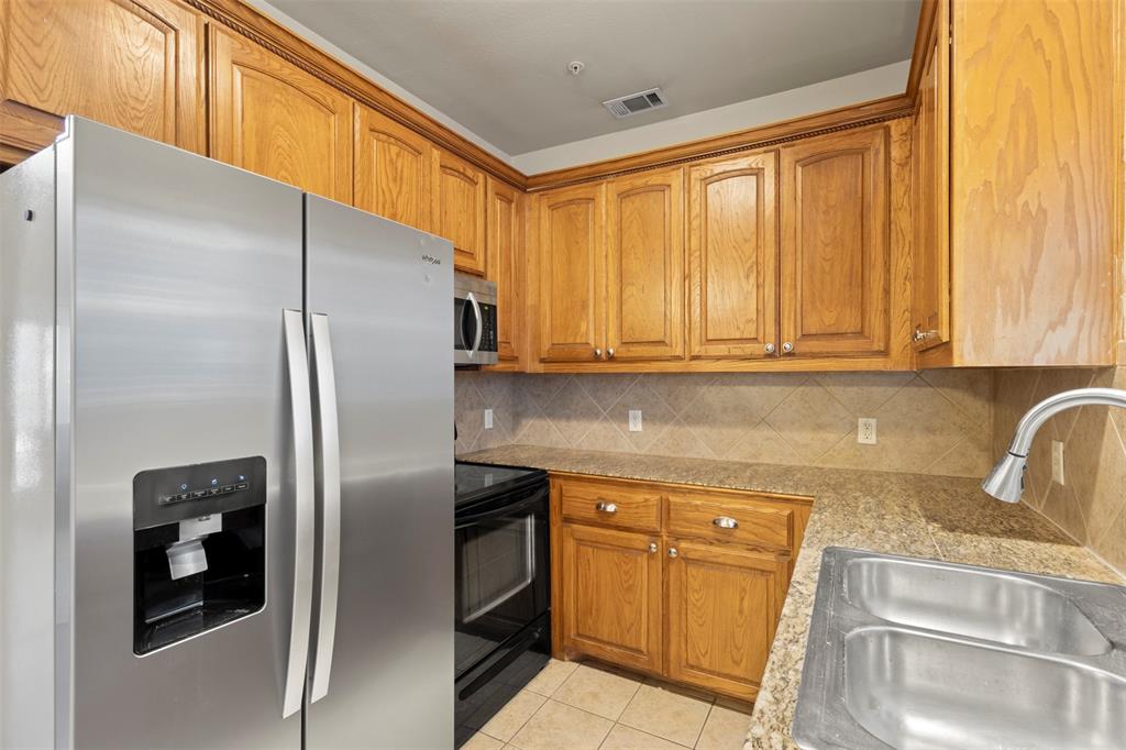 5617 Bryan Parkway, Unit 2 Dallas, TX 75206 - Photo 8 of 33 a kitchen with stainless steel appliances granite countertop a refrigerator and a sink