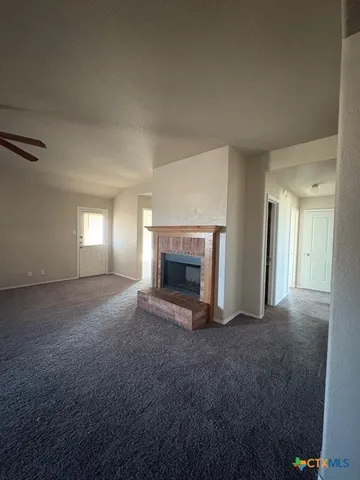 a view of empty room with a fireplace