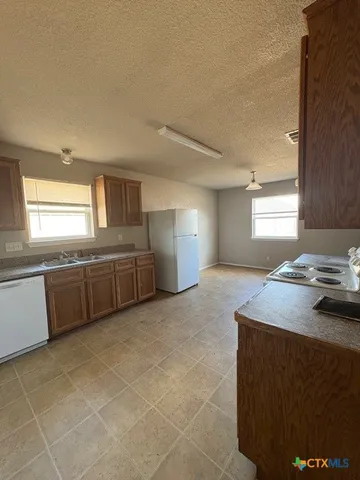a kitchen with stainless steel appliances granite countertop a sink and a stove