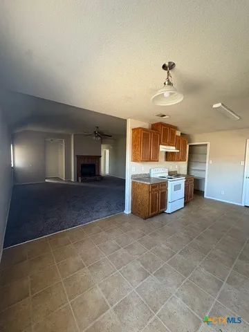 a view of a livingroom with furniture and a kitchen