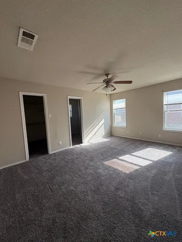 a view of empty room with window and fireplace