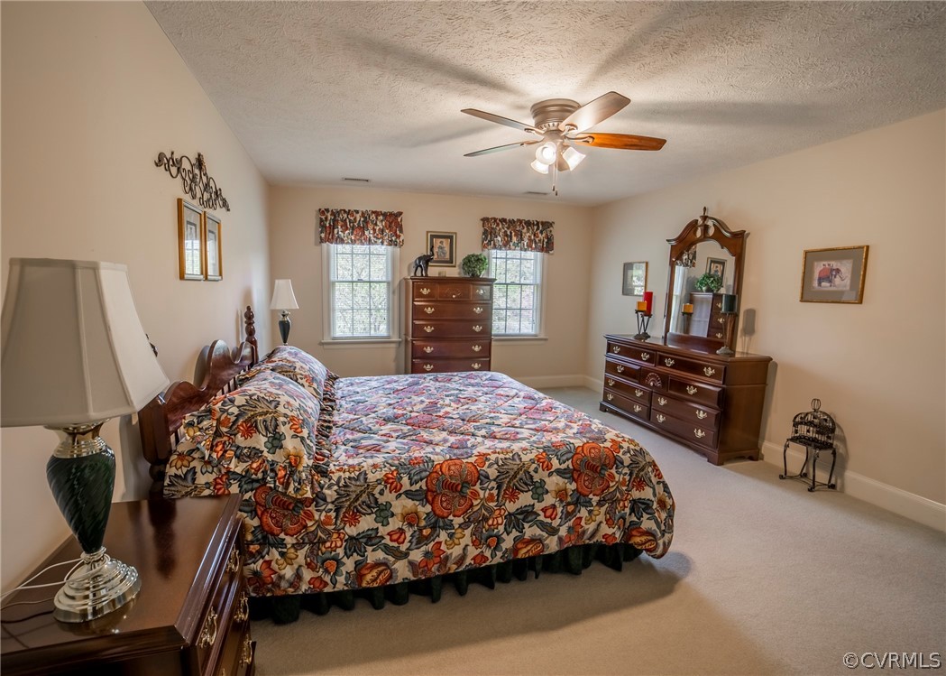 11239 Hanover Courthouse Road Hanover, VA 23069 - Photo 24 of 50 a bedroom with a bed a dresser and painting on the wall