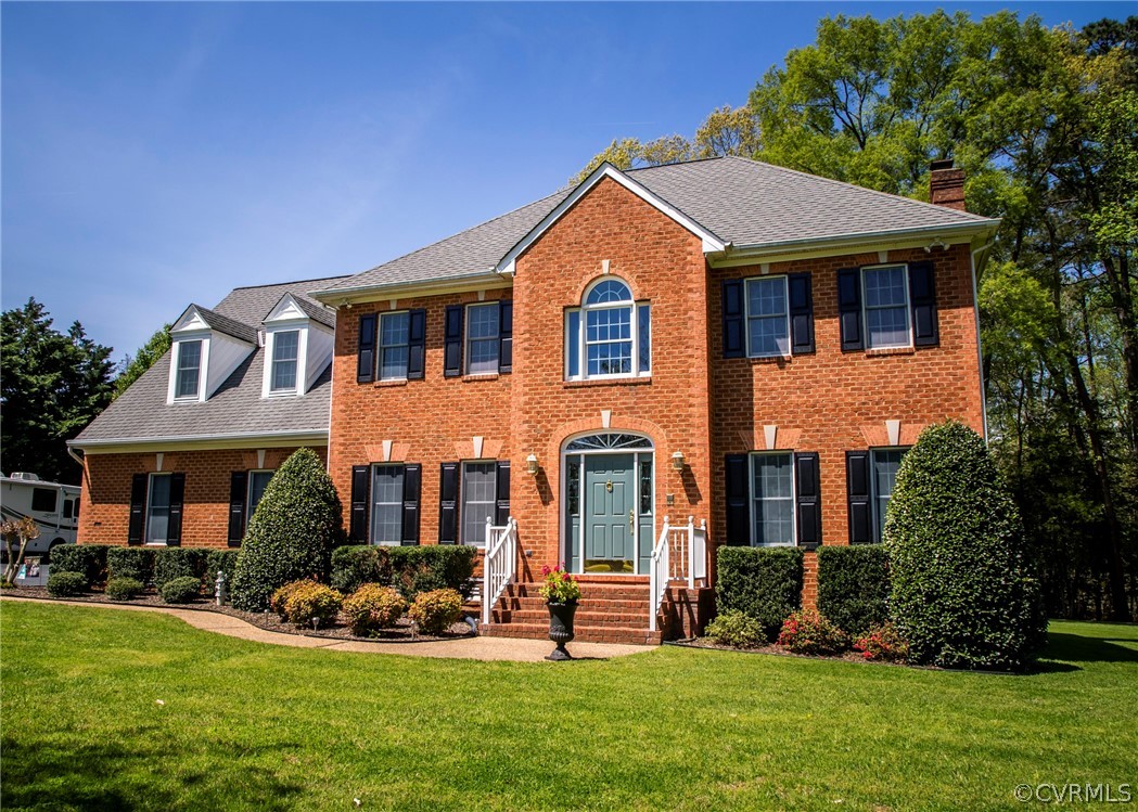 11239 Hanover Courthouse Road Hanover, VA 23069 - Photo 4 of 50 a front view of a house with a garden and plants