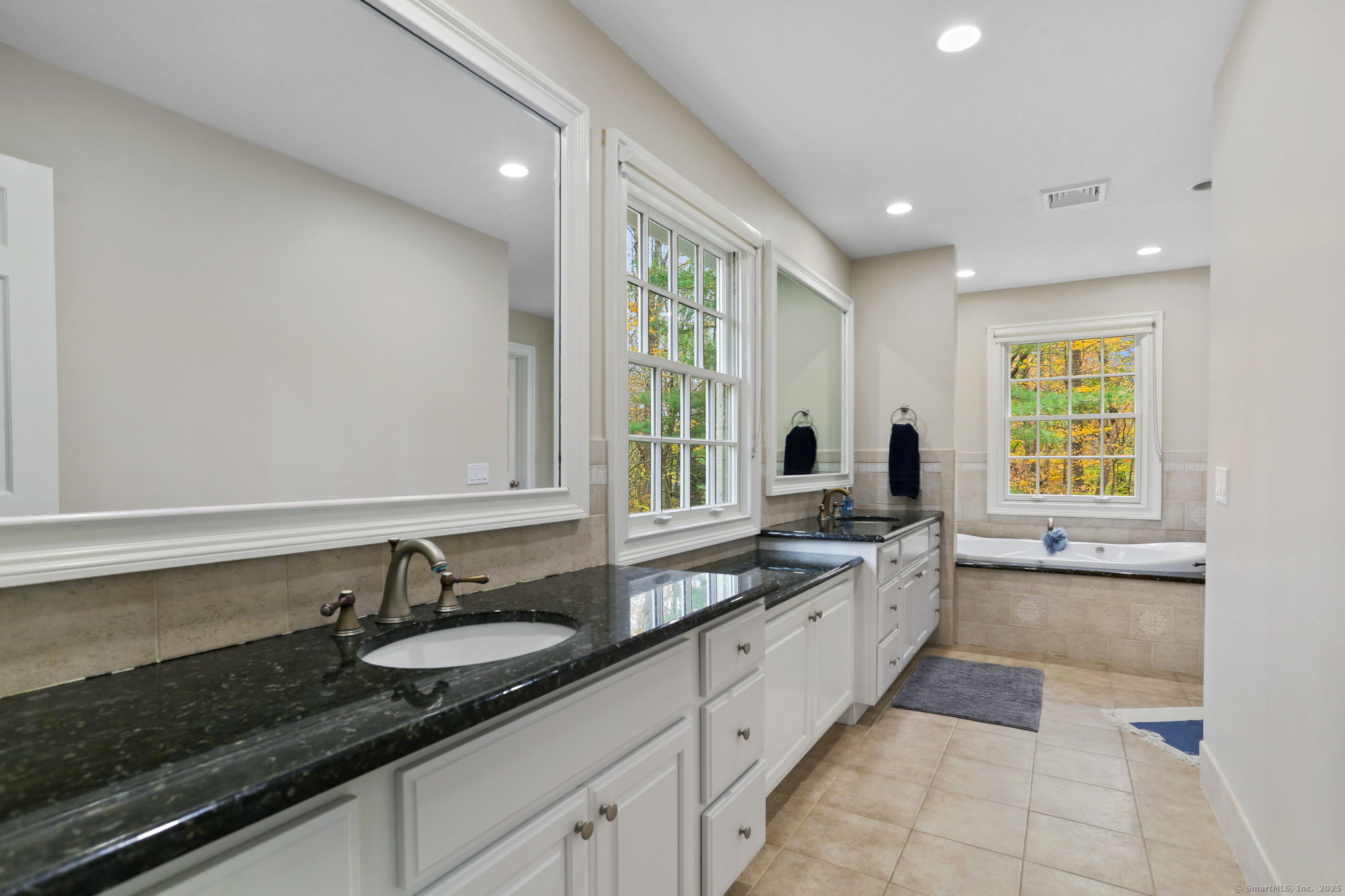 31 White Birch Road Weston, CT 06883 - Photo 28 of 37 a large bathroom with a granite countertop sink and a large mirror