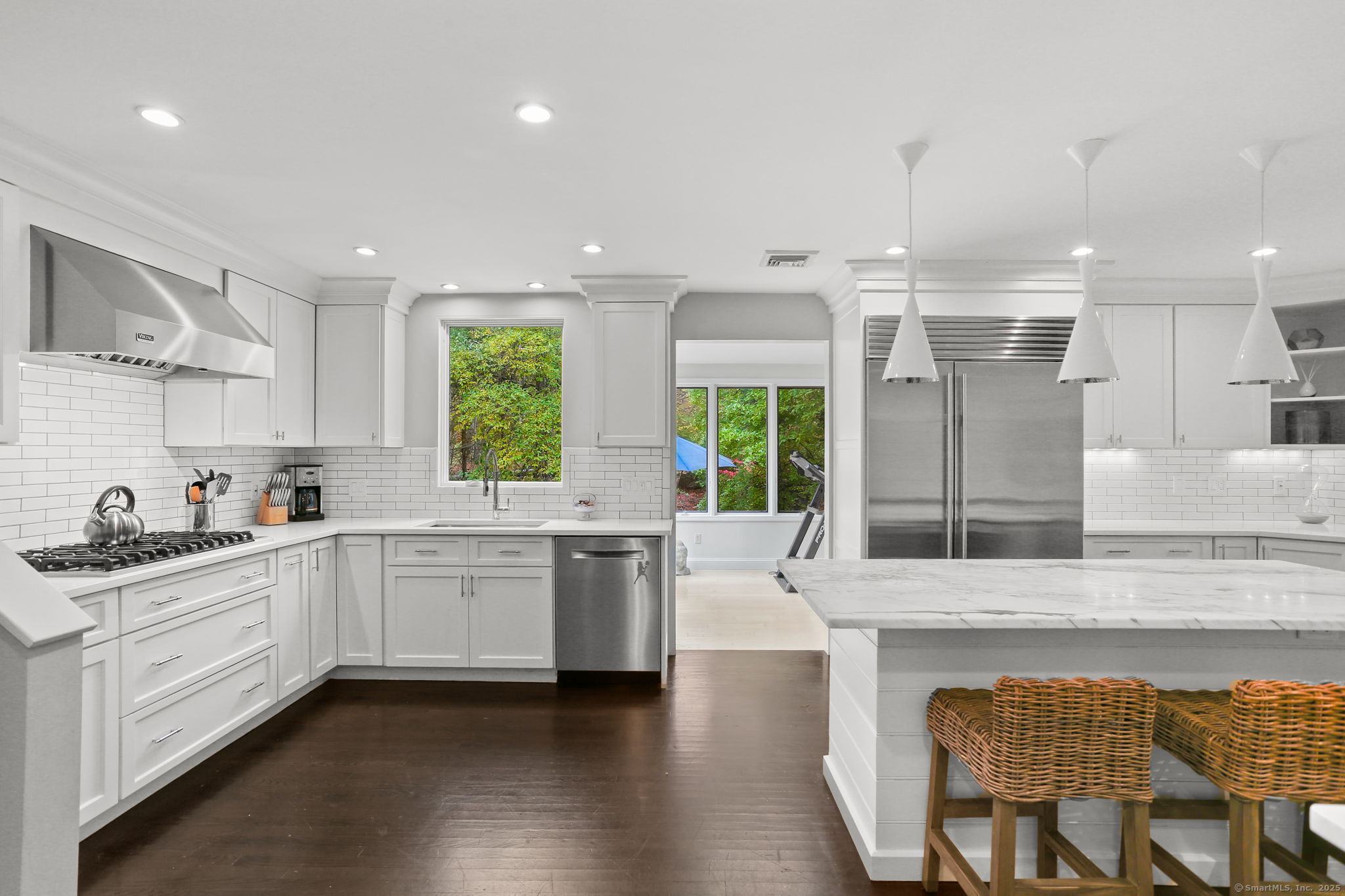 31 White Birch Road Weston, CT 06883 - Photo 3 of 37 a kitchen with stainless steel appliances granite countertop sink stove and white cabinets with wooden floor