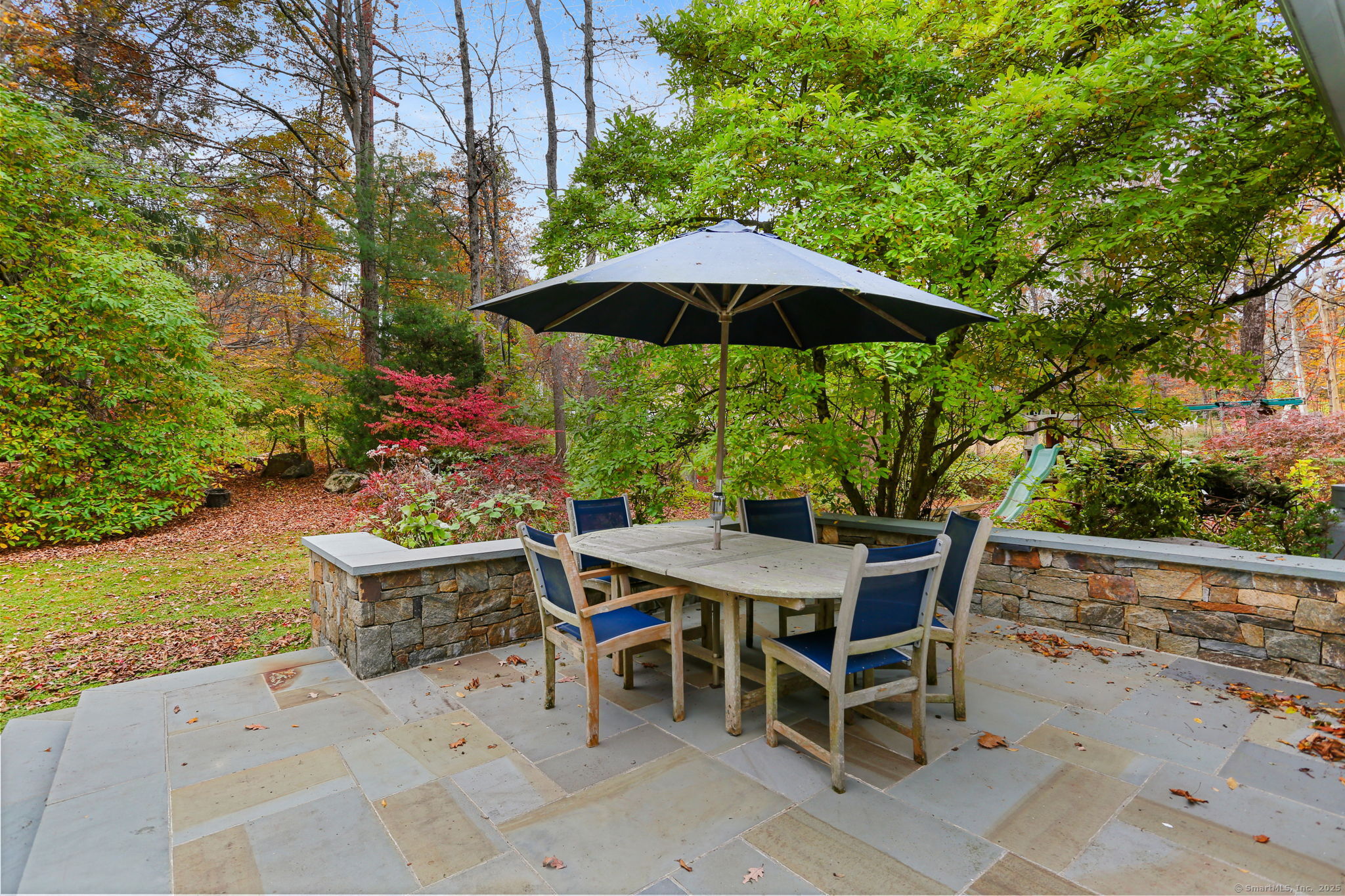 31 White Birch Road Weston, CT 06883 - Photo 33 of 37 a patio with a patio table and chairs