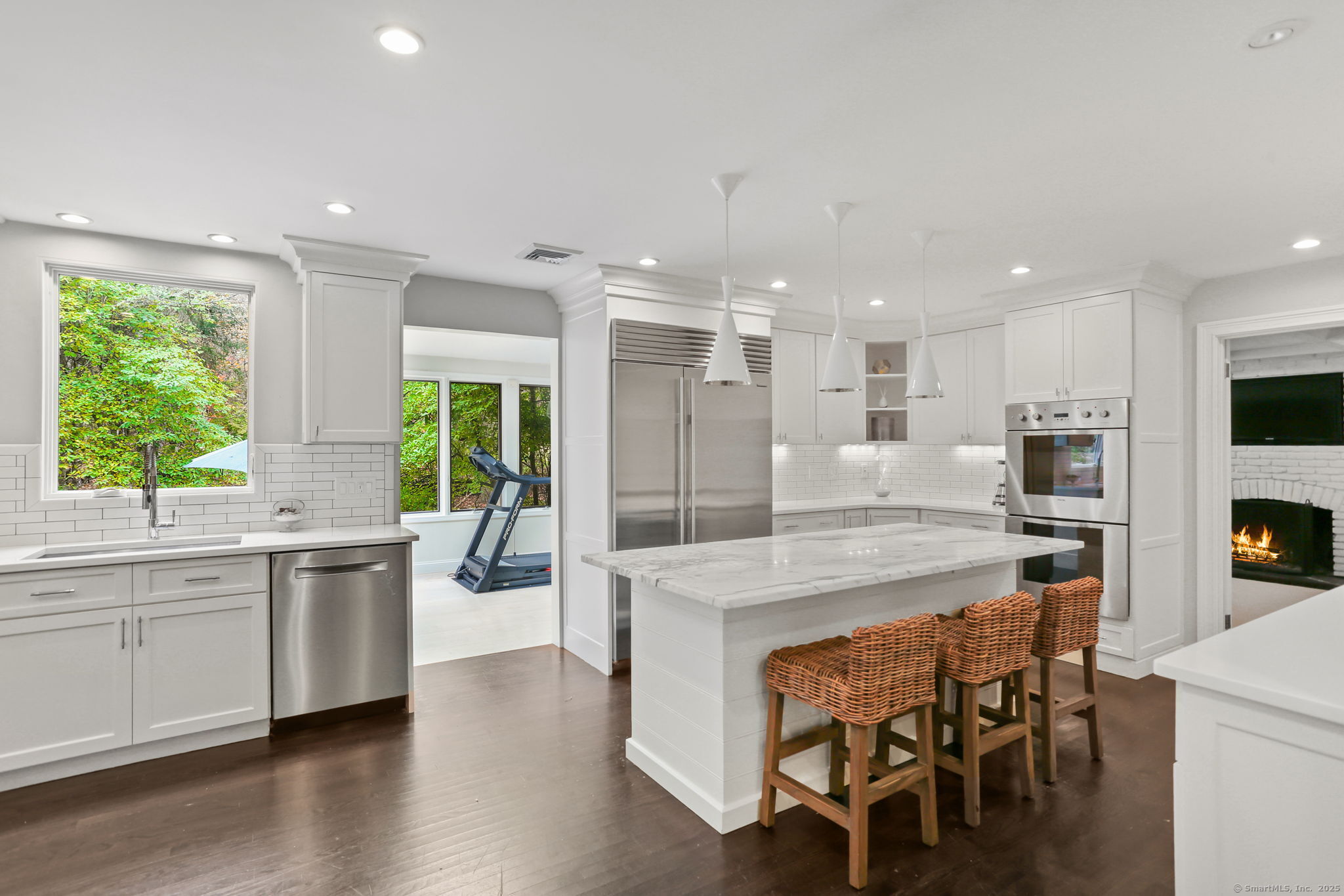 31 White Birch Road Weston, CT 06883 - Photo 4 of 37 a kitchen with kitchen island granite countertop wooden floor and stainless steel appliances