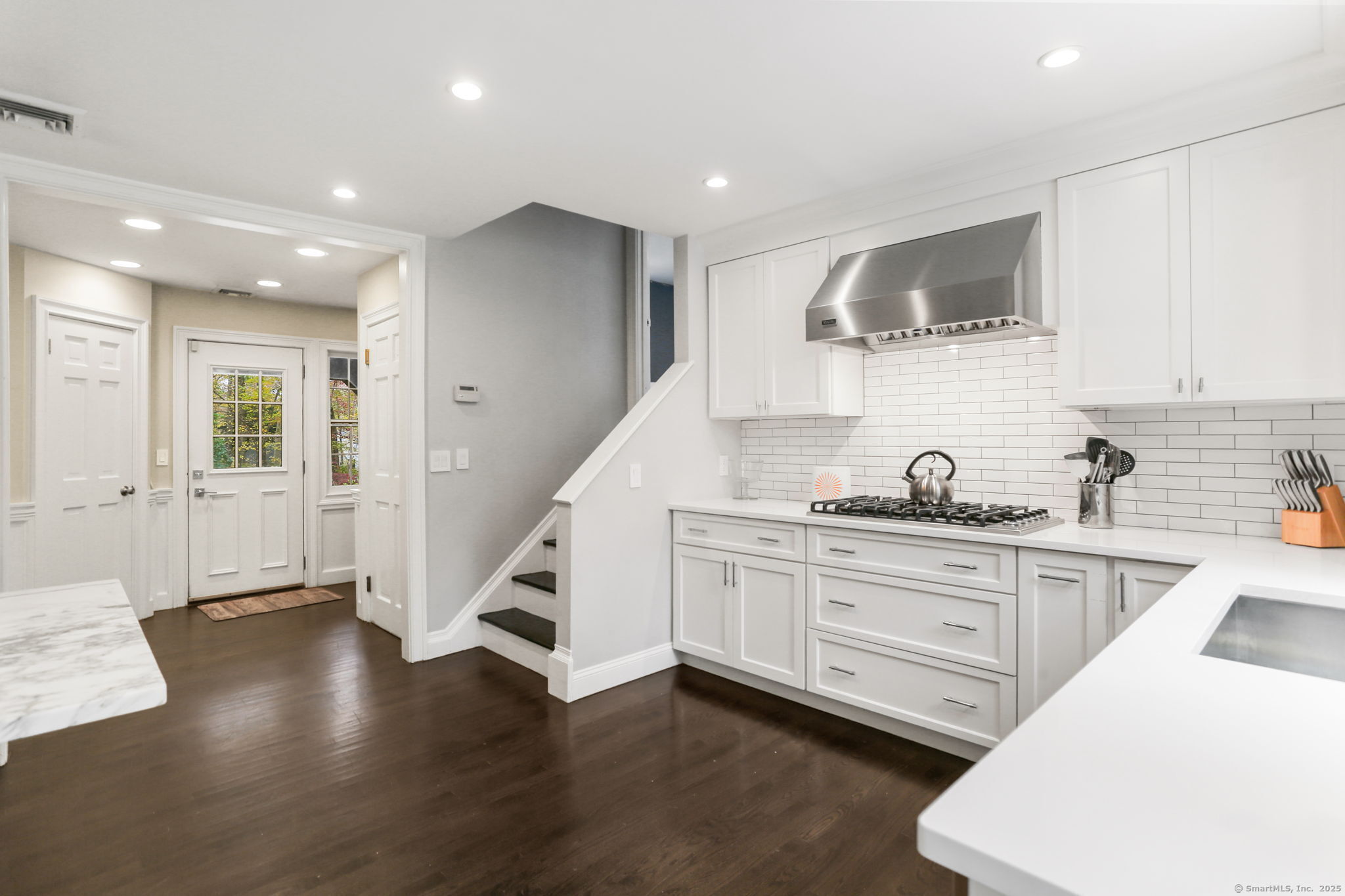 31 White Birch Road Weston, CT 06883 - Photo 6 of 37 a kitchen with stainless steel appliances granite countertop a sink a stove a refrigerator and cabinets