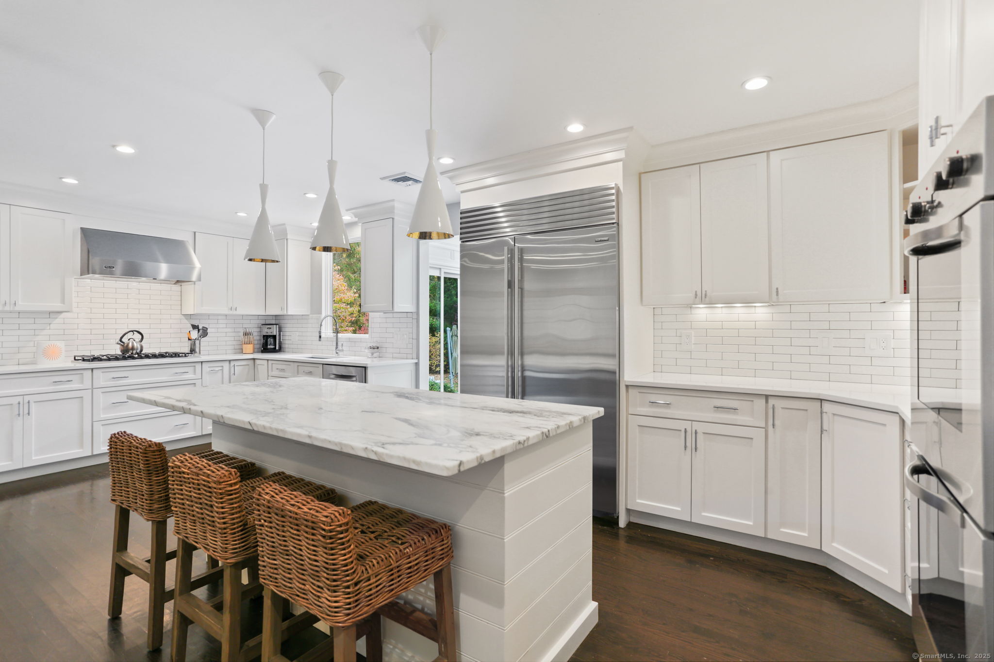 31 White Birch Road Weston, CT 06883 - Photo 8 of 37 a kitchen with kitchen island a sink stove and white cabinets