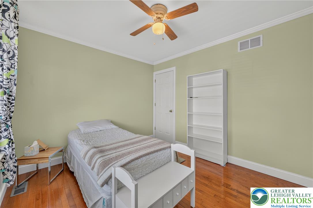1702 Red Bud Road Quakertown, PA 18951 - Photo 30 of 68 Hardwood floors and a ceiling fan create a comfortable atmosphere in this well-appointed bedroom.