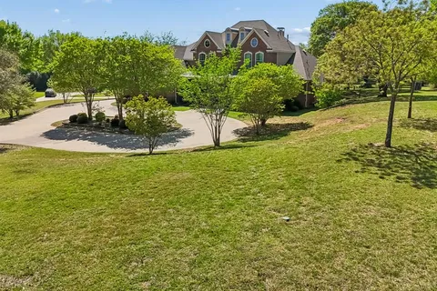 a view of a garden with a building in the background