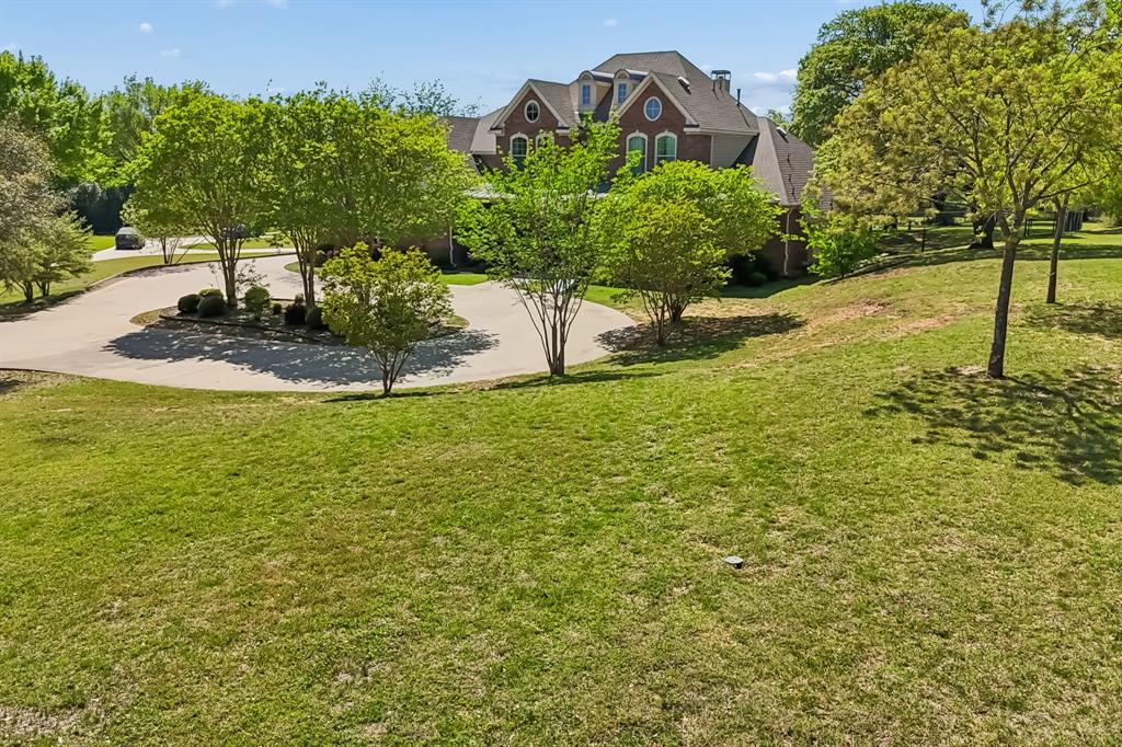 4604 Bill Simmons Road Colleyville, TX 76034 - Photo 4 of 22 a view of a garden with a building in the background