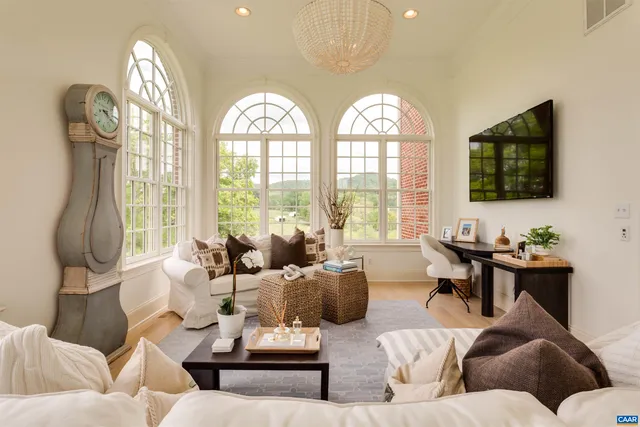 a living room with furniture or chandelier and a dining table