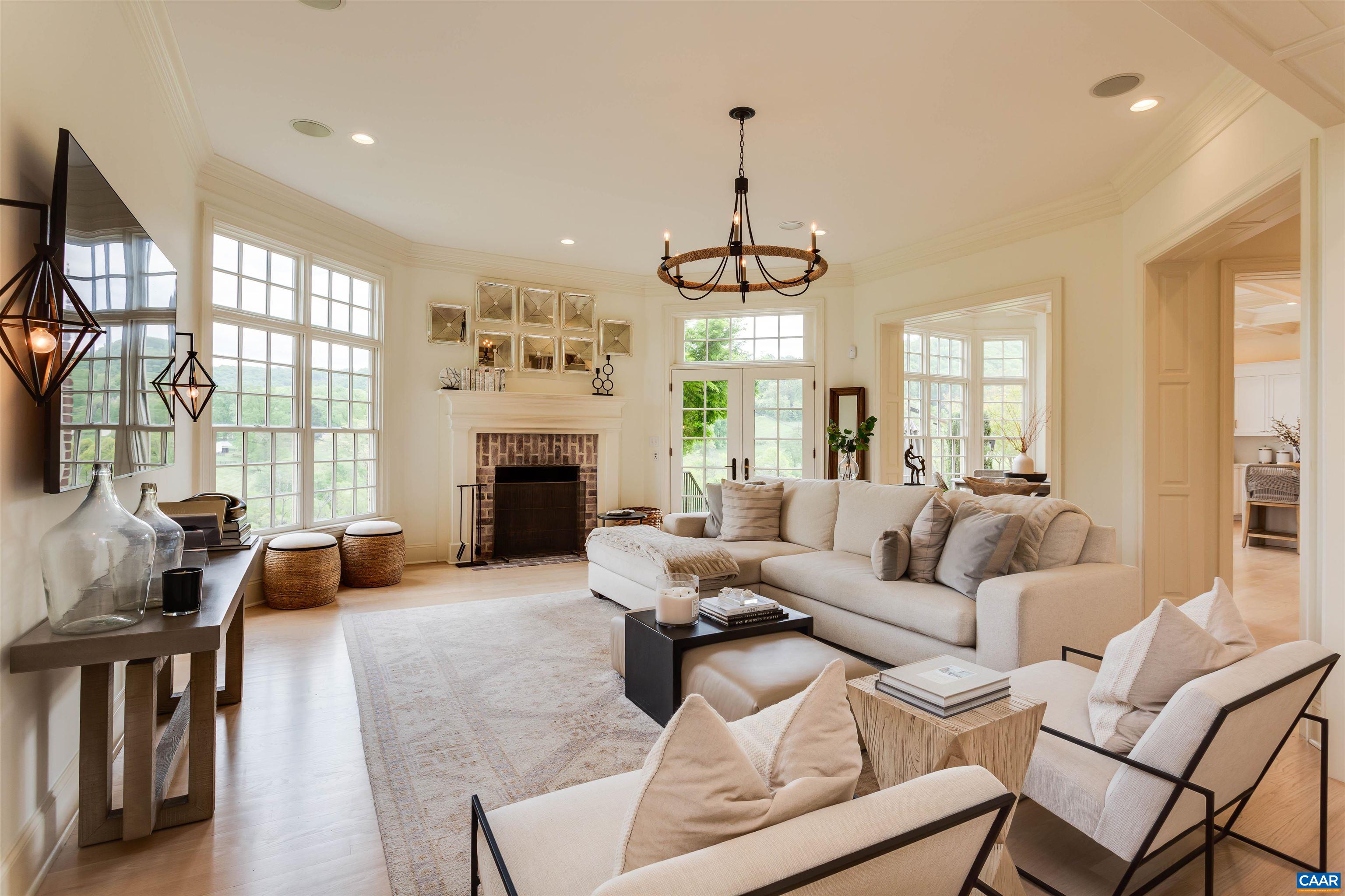 585 Ragged Mountain Drive Charlottesville, VA 22903 - Photo 13 of 60 a living room with furniture a large window and a fireplace
