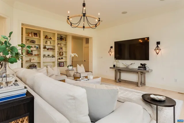 a living room with furniture and a floor to ceiling window