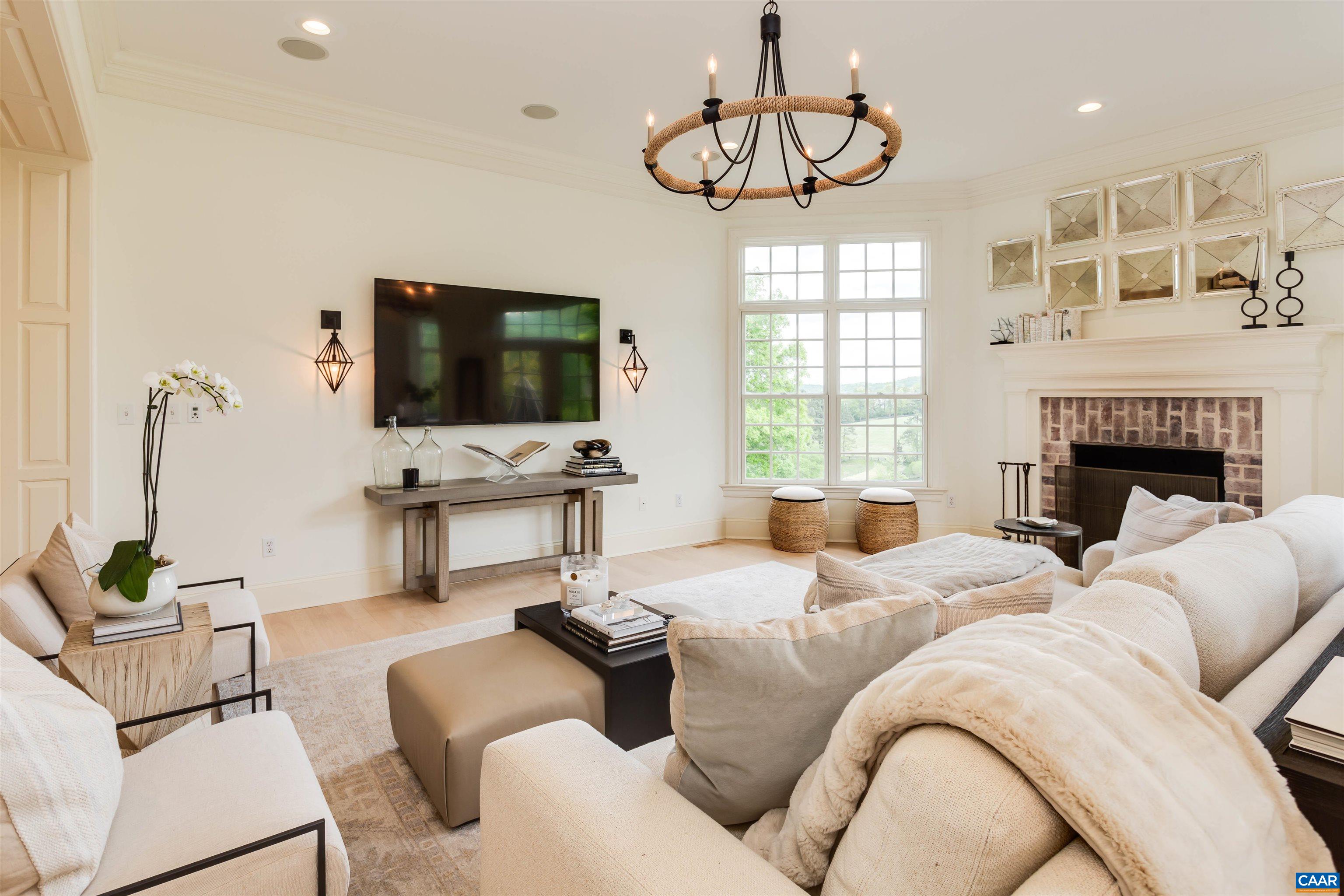 585 Ragged Mountain Drive Charlottesville, VA 22903 - Photo 16 of 60 a living room with furniture a fireplace and a flat screen tv