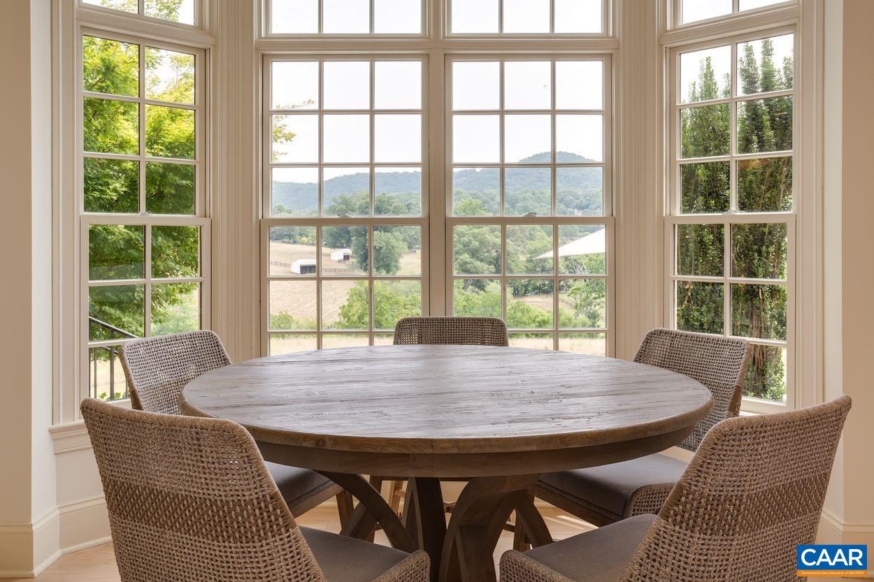585 Ragged Mountain Drive Charlottesville, VA 22903 - Photo 17 of 60 a view of a dining room with furniture window and outside view
