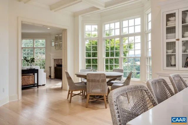 a kitchen with granite countertop white cabinets and a large window
