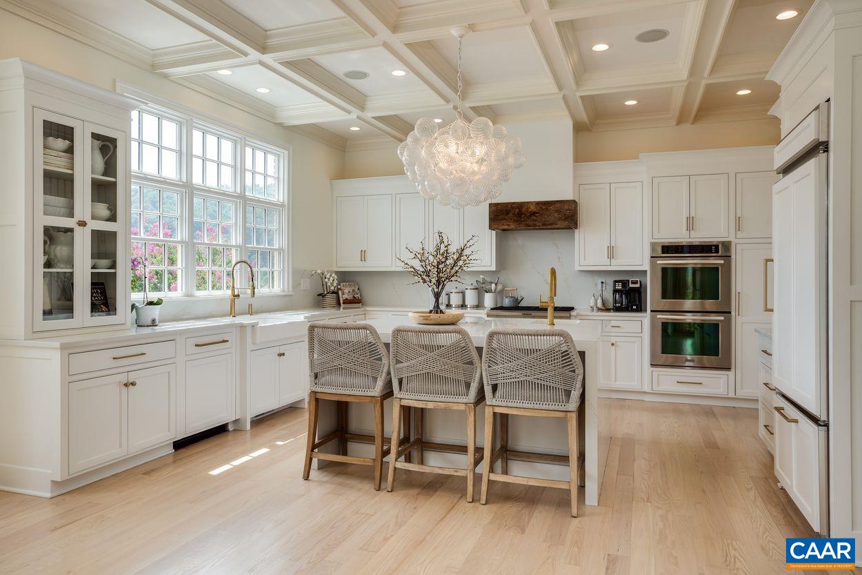585 Ragged Mountain Drive Charlottesville, VA 22903 - Photo 19 of 60 a kitchen with cabinets a sink dishwasher a dining table and chairs with wooden floor