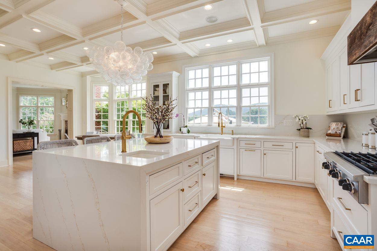 585 Ragged Mountain Drive Charlottesville, VA 22903 - Photo 20 of 60 a large white kitchen with a large window a sink and stainless steel appliances