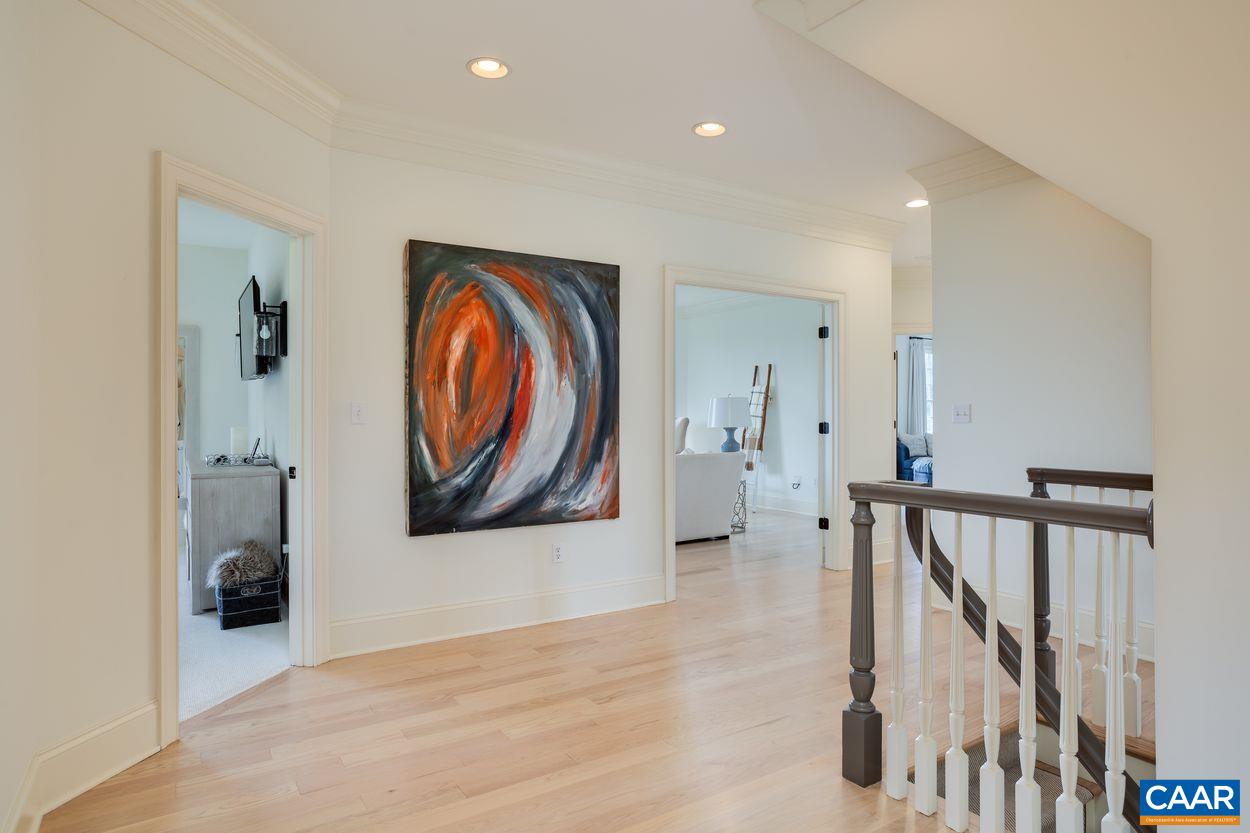 585 Ragged Mountain Drive Charlottesville, VA 22903 - Photo 22 of 60 a view of a hallway with paintings on the wall