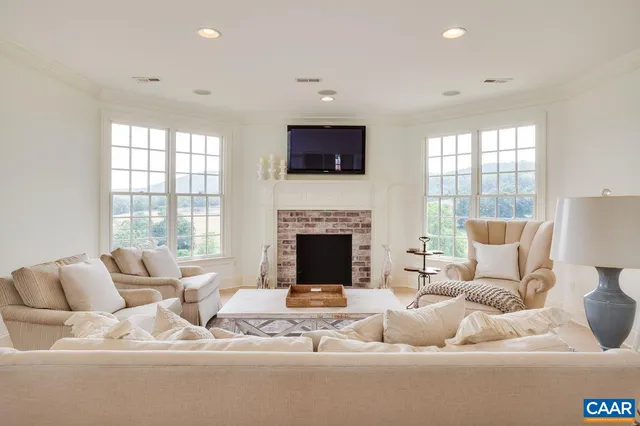 a spacious bedroom with two beds and a chandelier