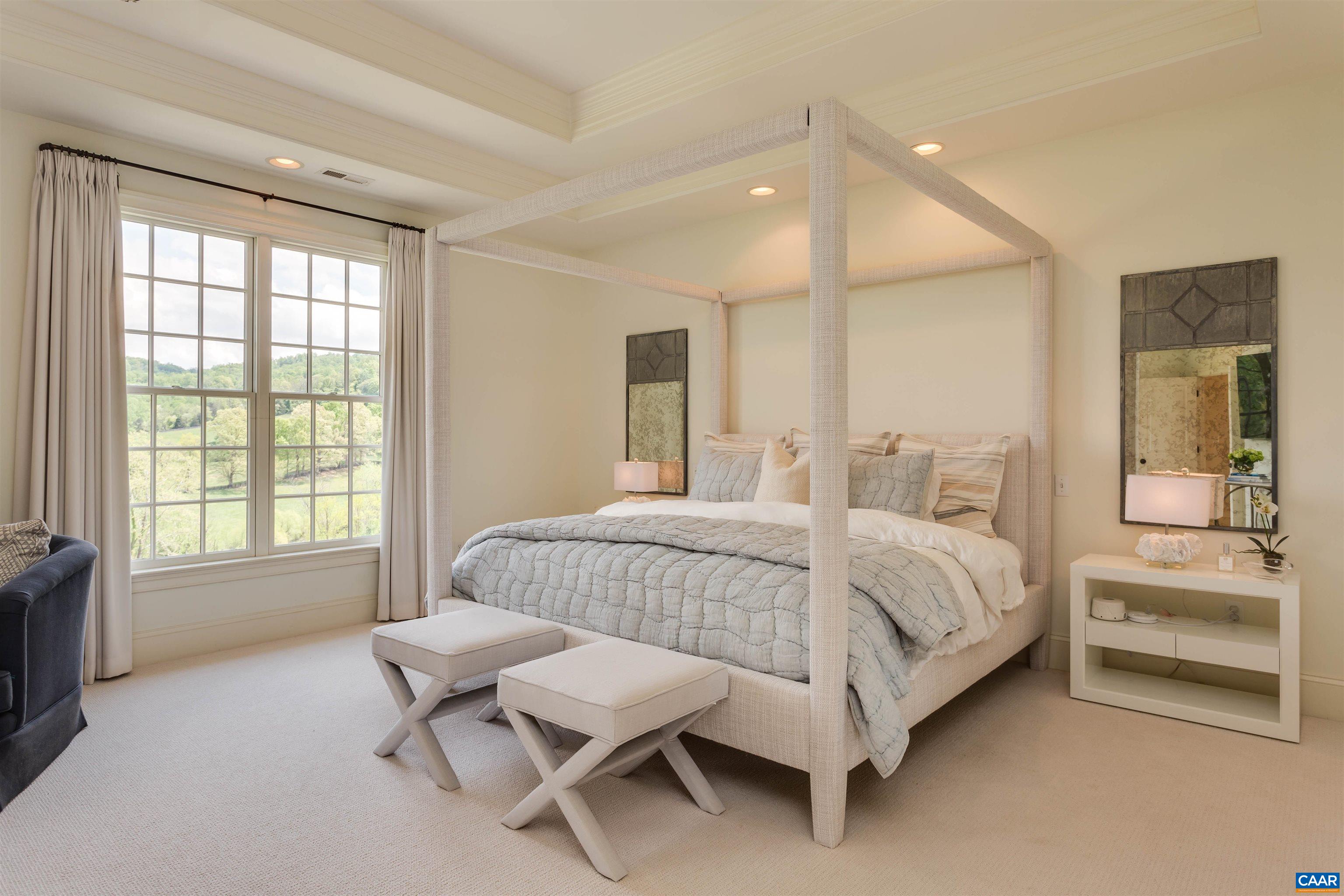 585 Ragged Mountain Drive Charlottesville, VA 22903 - Photo 28 of 60 a spacious bedroom with a bed and a couch