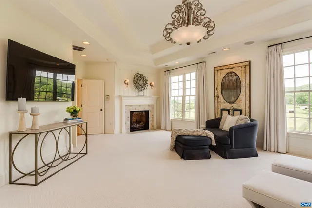 a living room with a fireplace with wooden floor