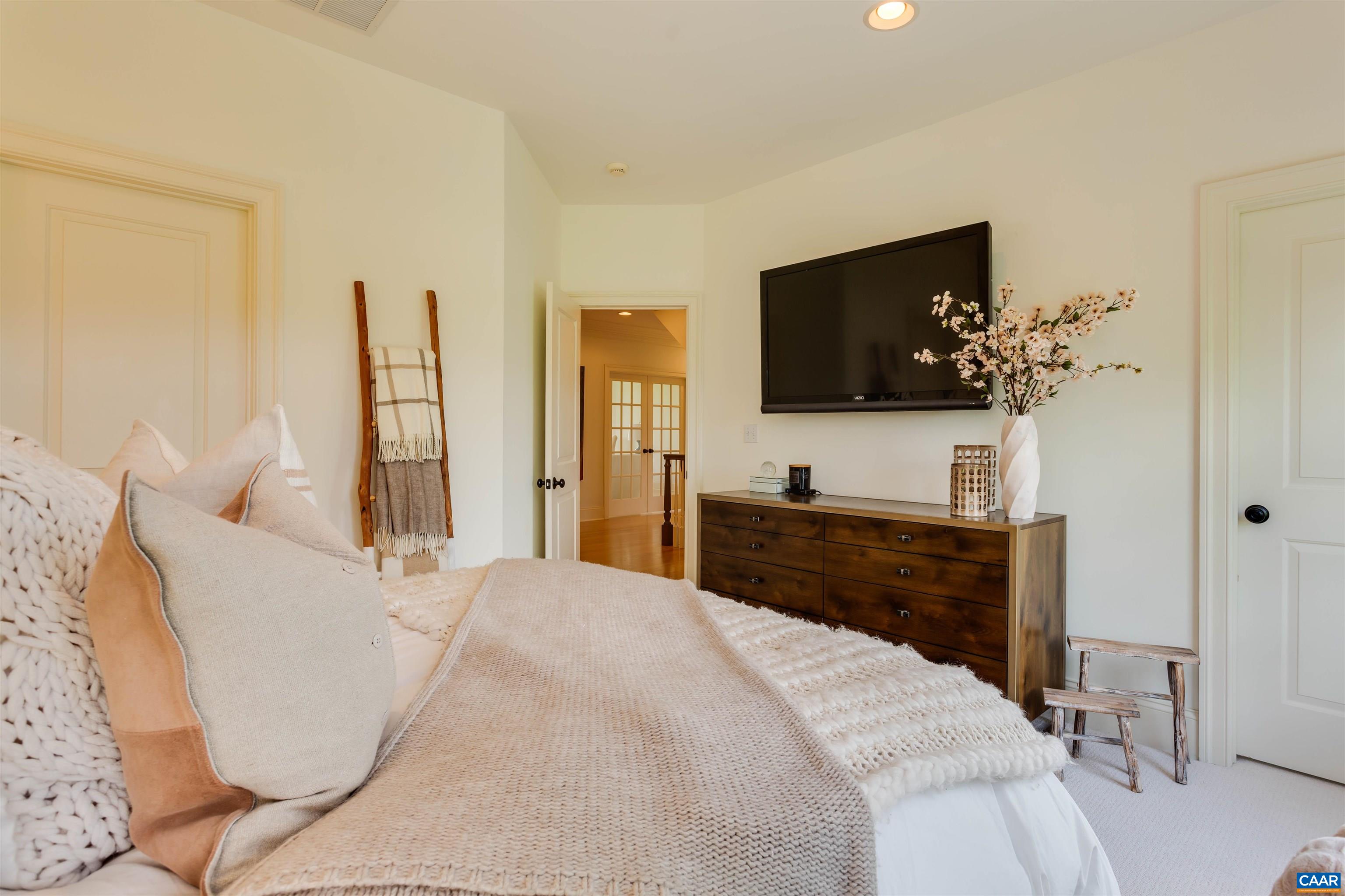 585 Ragged Mountain Drive Charlottesville, VA 22903 - Photo 37 of 60 a bedroom with a bed and a flat screen tv