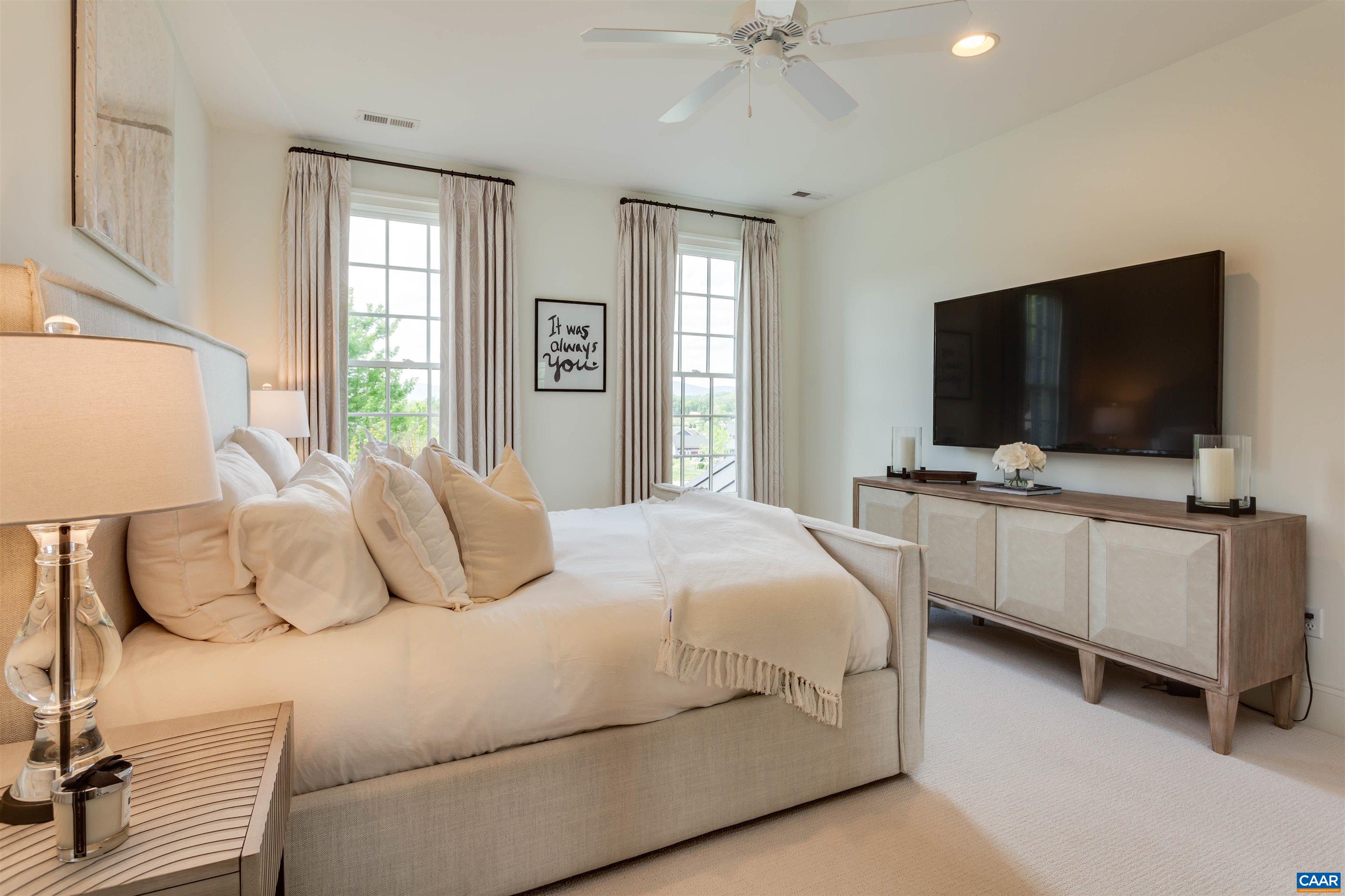 585 Ragged Mountain Drive Charlottesville, VA 22903 - Photo 40 of 60 a bedroom with a bed and a flat tv screen on dresser