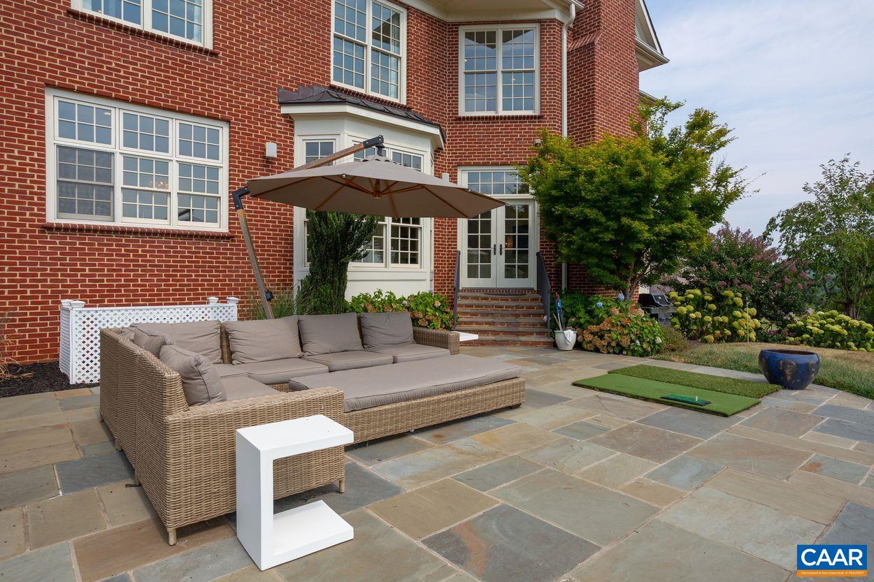 585 Ragged Mountain Drive Charlottesville, VA 22903 - Photo 43 of 60 a view of a patio with couches table and chairs and potted plants