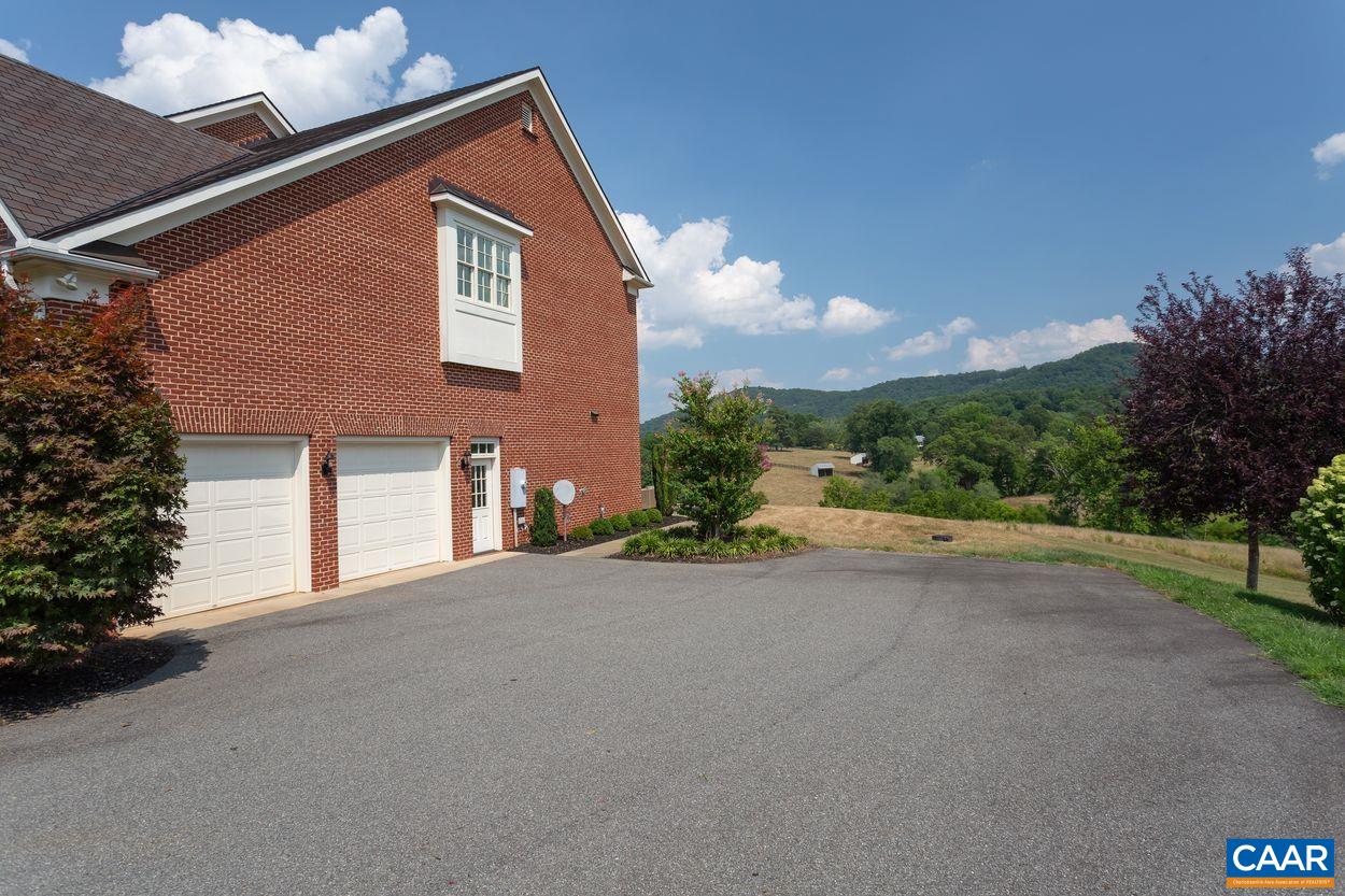 585 Ragged Mountain Drive Charlottesville, VA 22903 - Photo 48 of 60 a front view of a house with a yard and garage