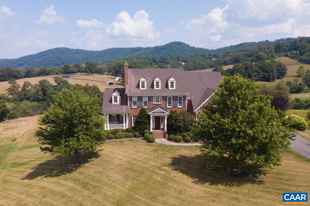 585 Ragged Mountain Drive Charlottesville, VA 22903 - Photo 52 of 60 a front view of a house with a yard and large trees