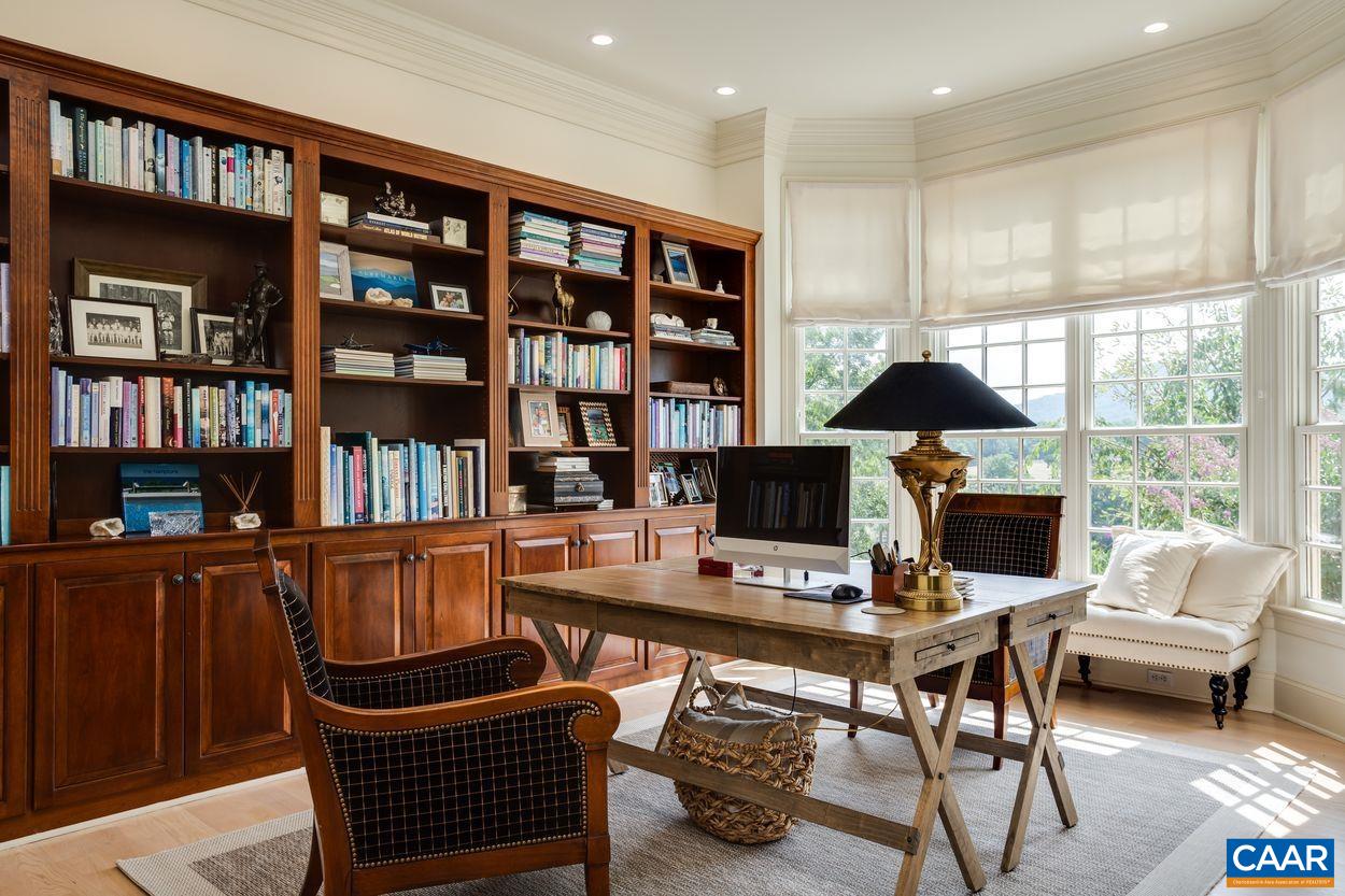 585 Ragged Mountain Drive Charlottesville, VA 22903 - Photo 9 of 60 a workspace with furniture and book shelf