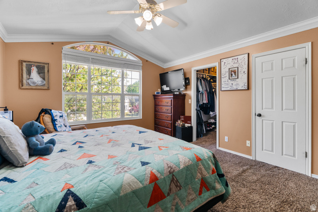 5727 South 3550th Street West Roy, UT 84067 - Photo 9 of 49 Master bedroom featuring a large arched window, vaulted ceiling, and crown molding