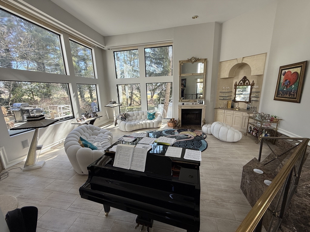 132 Yarmouth Road Brookline, MA 02467 - Photo 4 of 22 a living room with furniture fireplace and large windows
