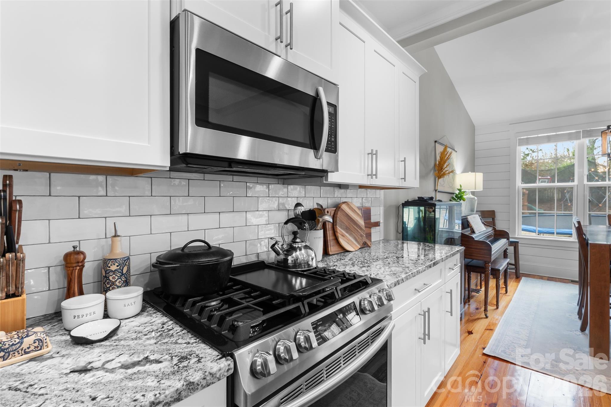 276 Belle Ridge Road Elgin, SC 29045 - Photo 11 of 45 a kitchen with granite countertop a stove and a wooden floor