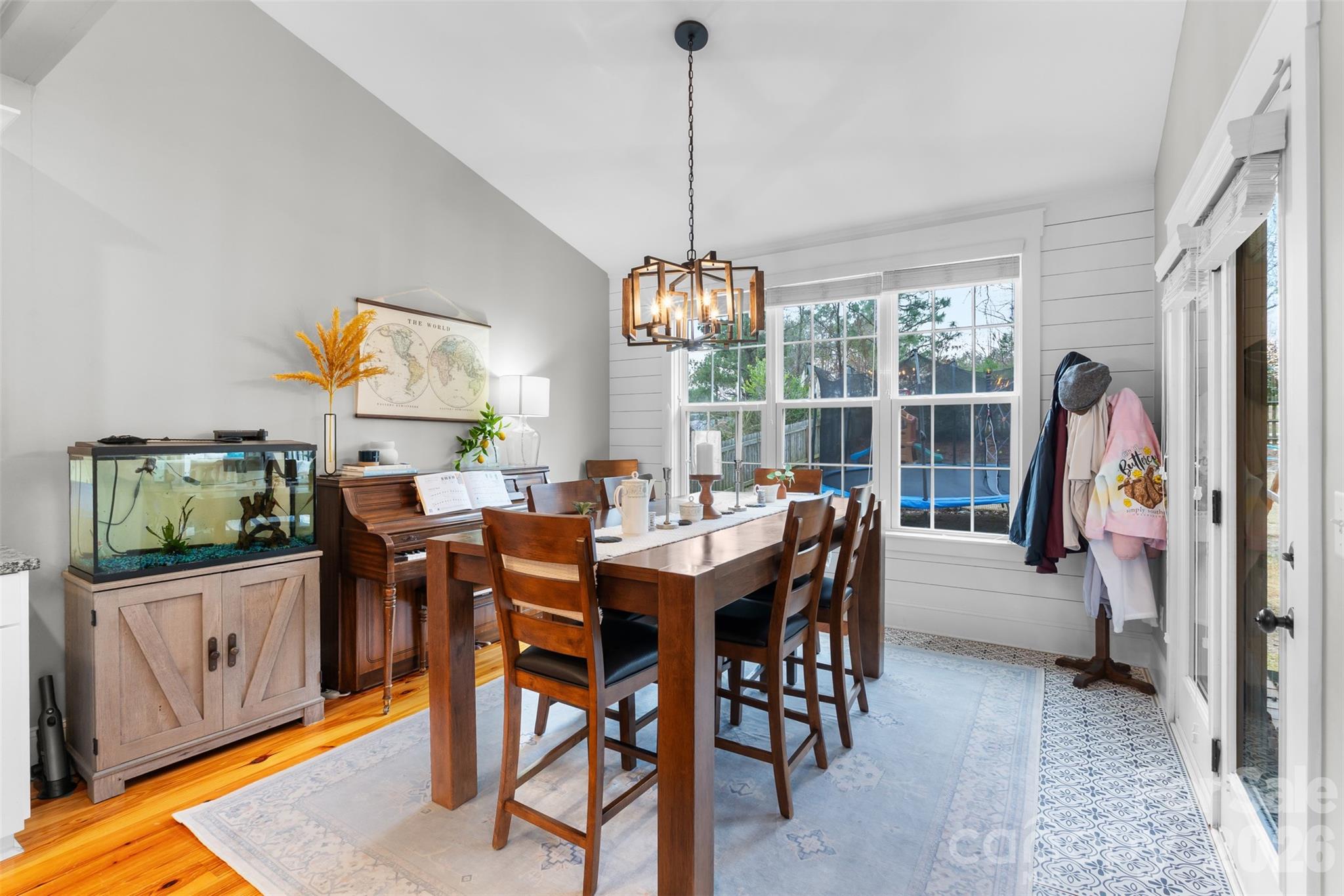 276 Belle Ridge Road Elgin, SC 29045 - Photo 13 of 45 a view of a dining room and livingroom furniture wooden floor a rug a flat screen tv a rug a painting and a chandelier