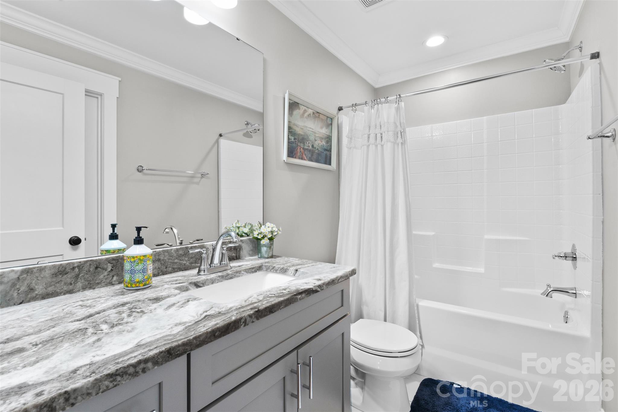 276 Belle Ridge Road Elgin, SC 29045 - Photo 32 of 45 a bathroom with a granite countertop sink a toilet a mirror a bathtub and shower