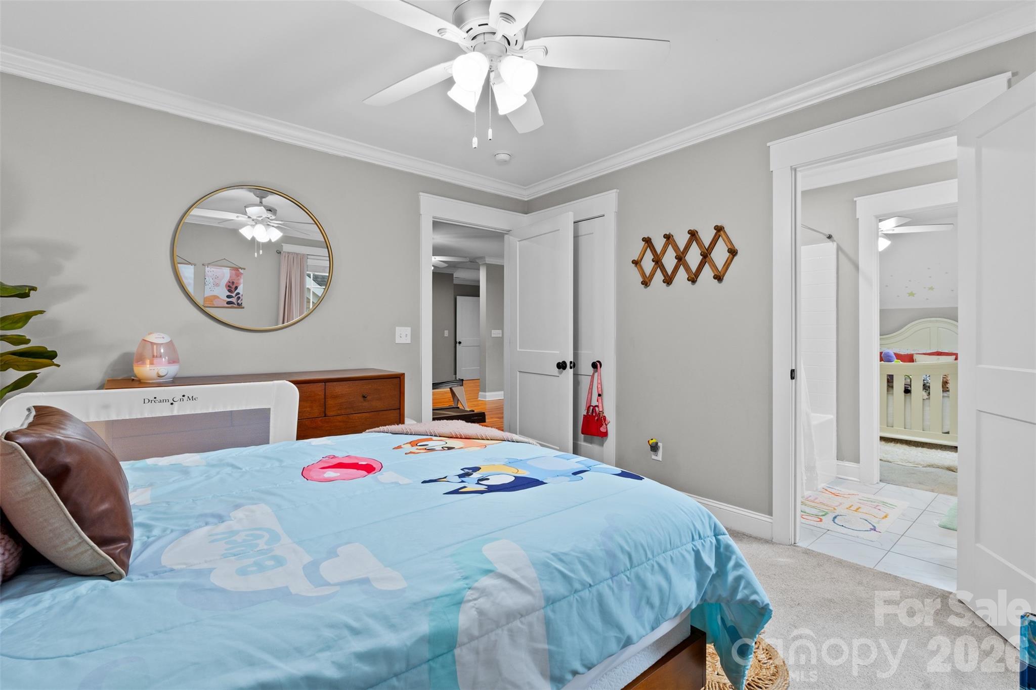 276 Belle Ridge Road Elgin, SC 29045 - Photo 35 of 45 a bedroom with a bed and a chandelier