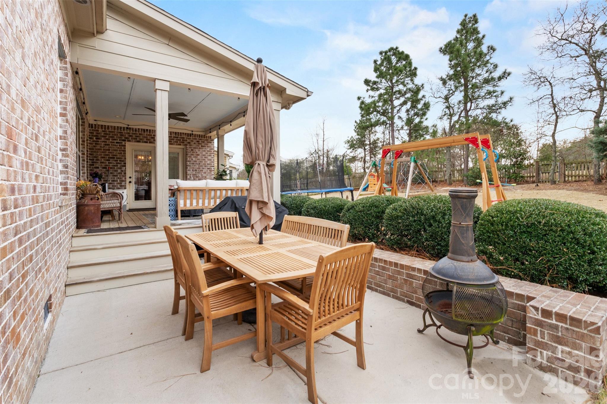 276 Belle Ridge Road Elgin, SC 29045 - Photo 40 of 45 a view of a patio with a table and chairs and a floor to ceiling window
