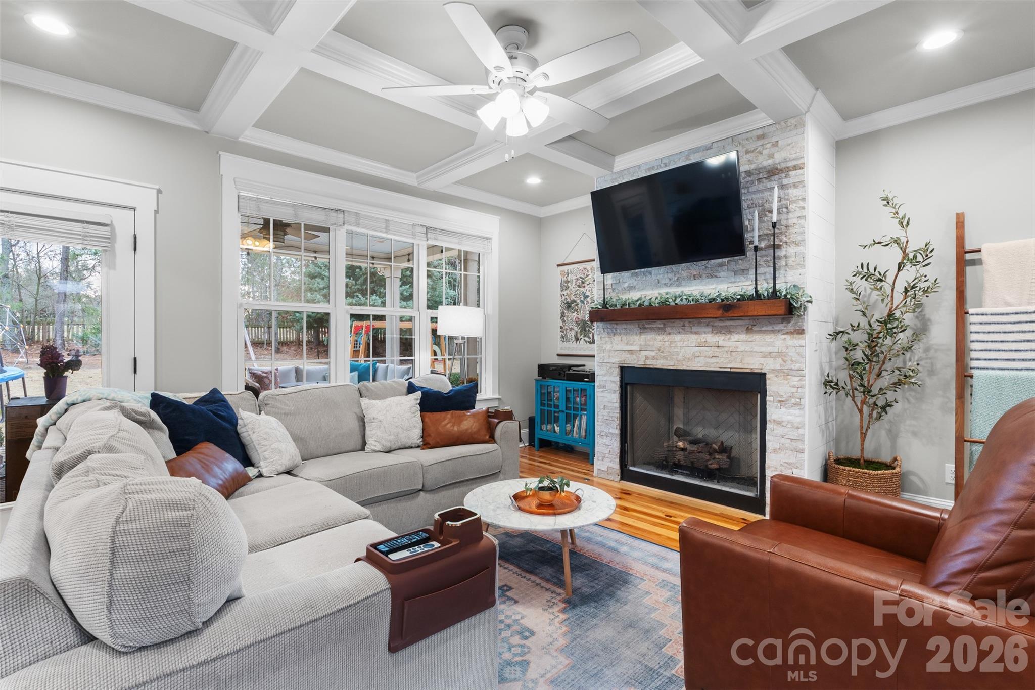 276 Belle Ridge Road Elgin, SC 29045 - Photo 6 of 45 a living room with furniture a flat screen tv and a fireplace