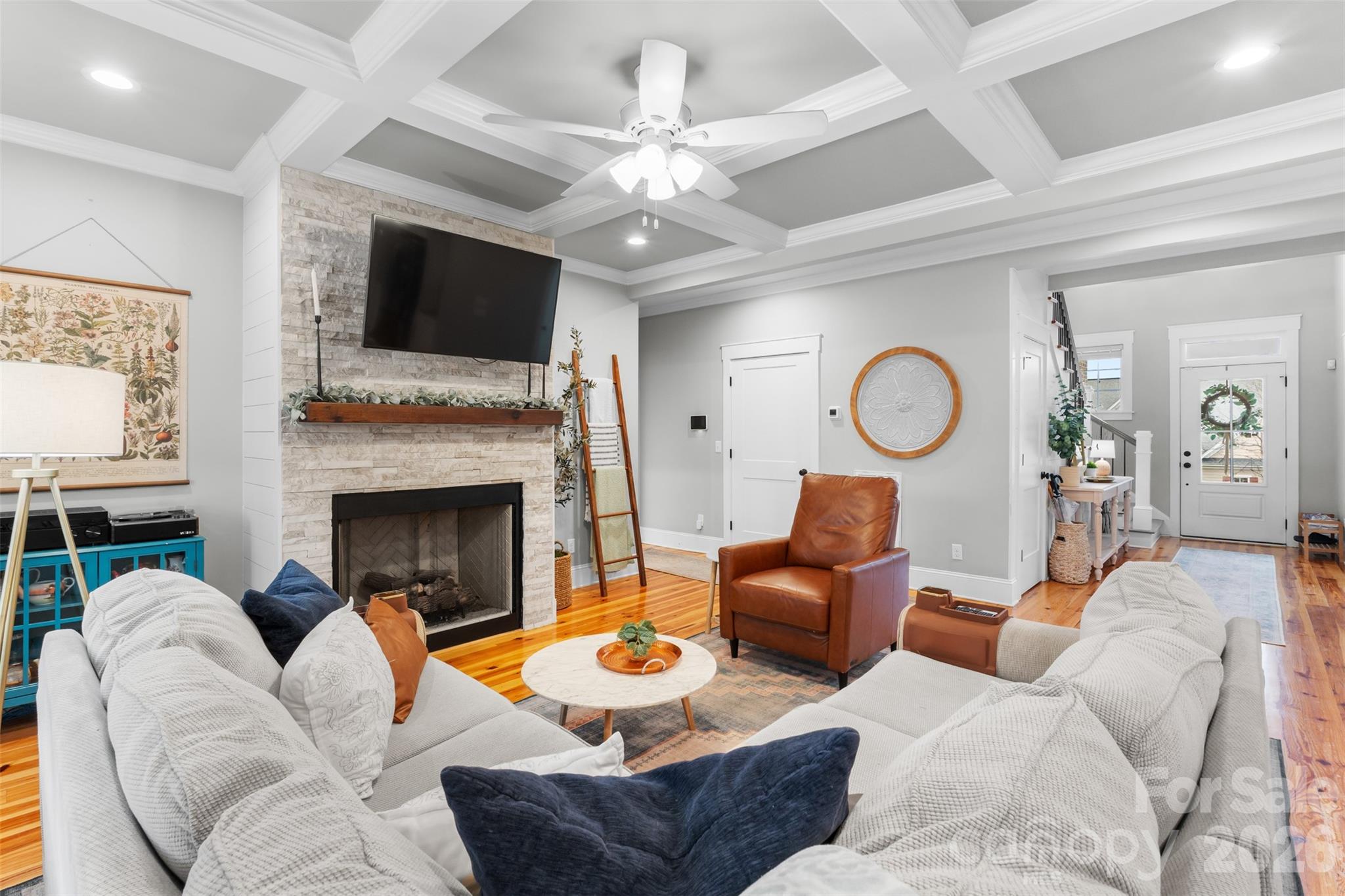 276 Belle Ridge Road Elgin, SC 29045 - Photo 7 of 45 a living room with furniture a fireplace and a flat screen tv